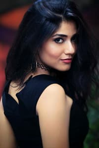 Sainee Raj in INT. CAFÉ – NIGHT